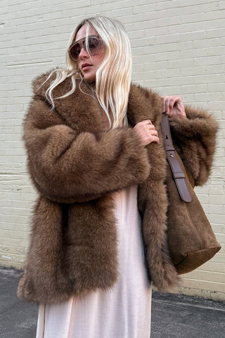 golden-brown-recycled-polyester-faux-fur-coat-laid-flat-showing-wide-collar-and-walnut-damask-belt-detail