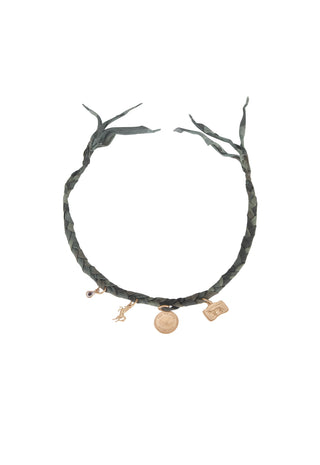 a-dark-green-braided-leather-necklace-with-branch-like-ends-and-three-gold-toned-charms-including-a-small-horse-figure-and-a-round-medallion-shown-on-a-plain-white-background